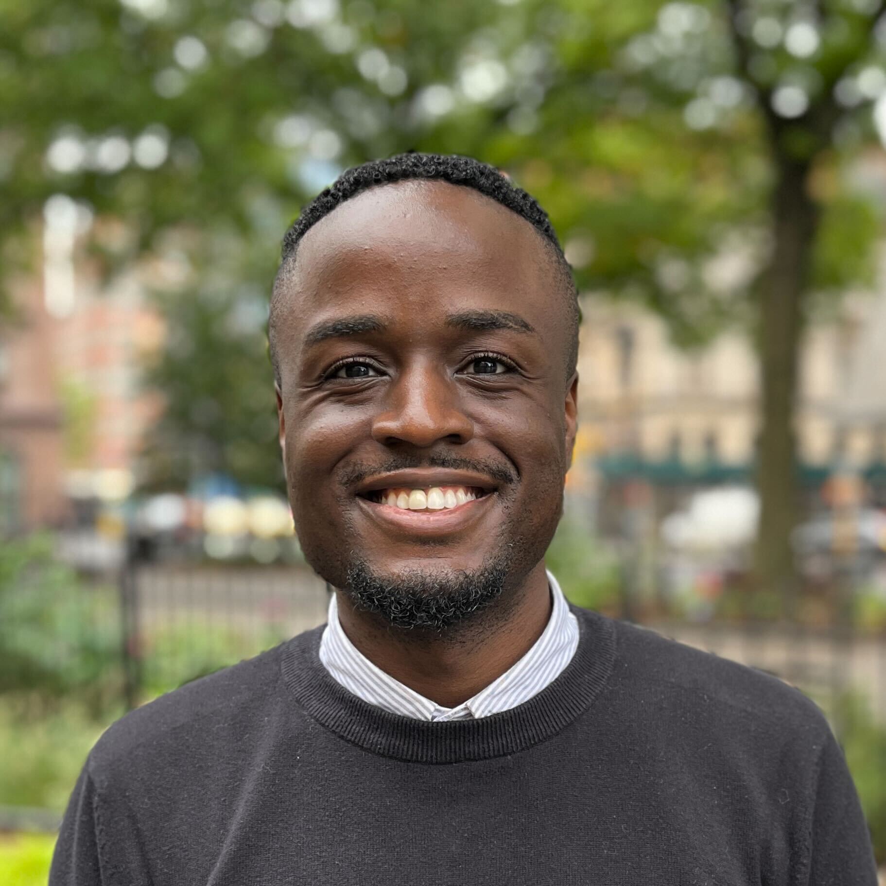Brandon Phillips smiles in a lush green park.
