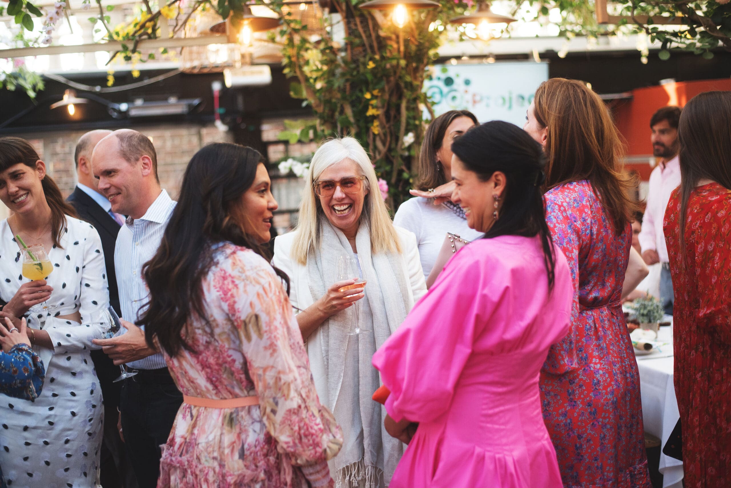 A group of attendees stand together and converse.