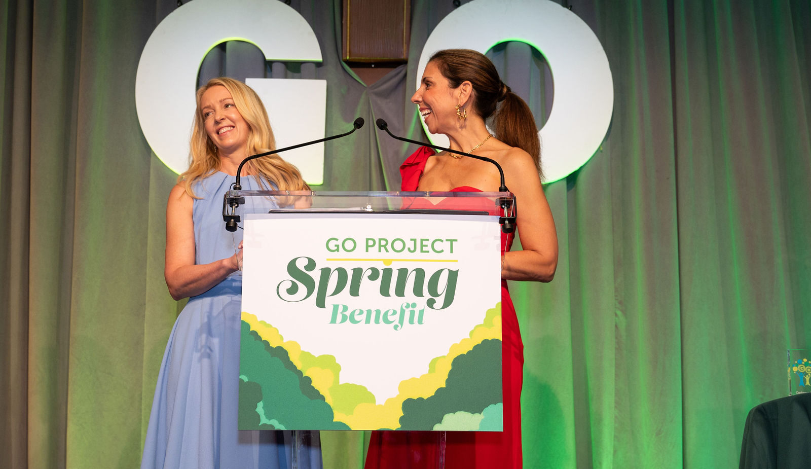 Two people at a podium looking at each other.