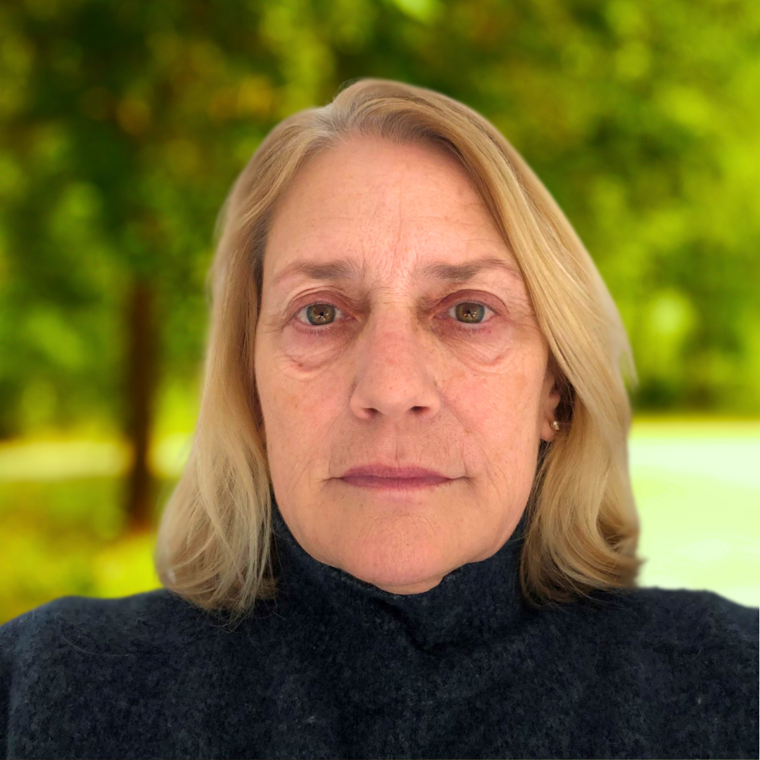 Theresa Grimming smiles in a lush green park.